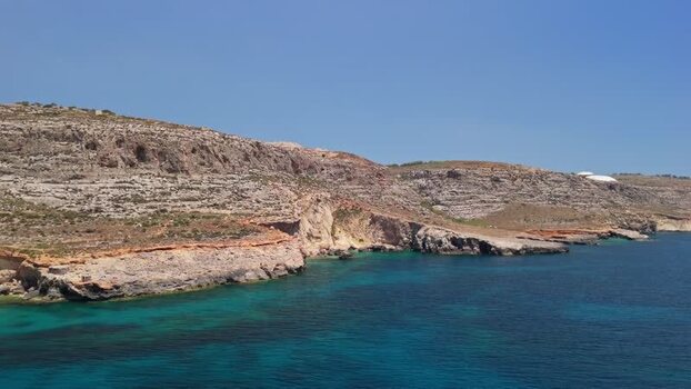 Aerial view of Ghar Lapsi bay Malta with rocky cliffs and turquoise water Aerial view of Ghar Lapsi bay Malta with rocky cliffs and turquoise water