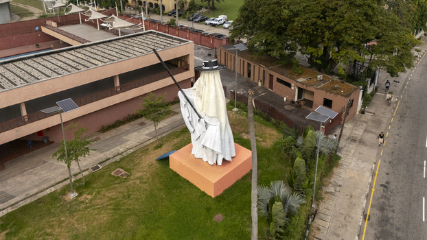 Aerial view of the Eyo Festival statue on Lagos Island surrounded by green lawns modern buildings and nearby roads in Lagos Lagos Nigeria. Aerial view of the Eyo Festival statue on Lagos Island surrounded by green lawns modern buildings and nearby roads in Lagos Lagos Nigeria.
