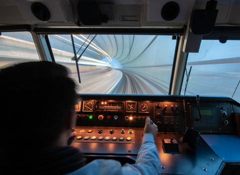 View of a train driver operating a train inside the tunnel at Amsterdam Airport Schiphol with motion blur on the tunnel walls Schiphol Noord Holland Netherlands. View of a train driver operating a train inside the tunnel at Amsterdam Airport Schiphol with motion blur on the tunnel walls Schiphol Noord Holland Netherlands.