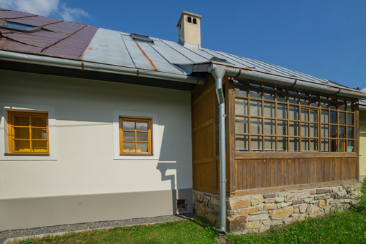 View of a quaint building with a stone foundation and wood framed porch basks under a clear sky blending rustic charm with simple elegance Donovaly Slovakia. View of a quaint building with a stone foundation and wood framed porch basks under a clear sky blending rustic charm with simple elegance Donovaly Slovakia.