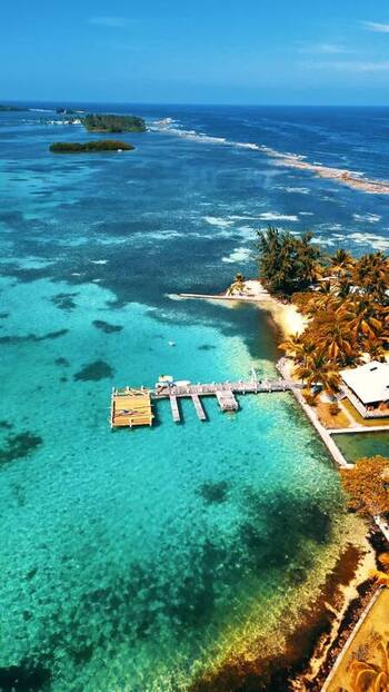 Aerial view of turquoise waters and a wooden pier on the coast Honduras. Aerial view of turquoise waters and a wooden pier on the coast Honduras.