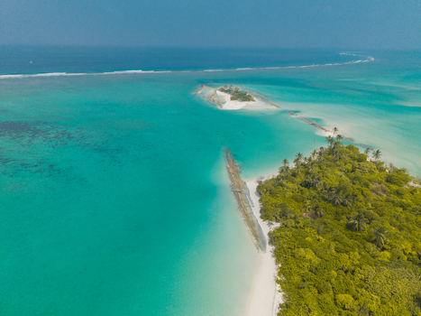 Aerial view of pristine tropical islands where vibrant turquoise waters meet dazzling white sands and lush green foliage Thuraakunu Thiladhunmathee Uthuruburi Maldives. Aerial view of pristine tropical islands where vibrant turquoise waters meet dazzling white sands and lush green foliage Thuraakunu Thiladhunmathee Uthuruburi Maldives.