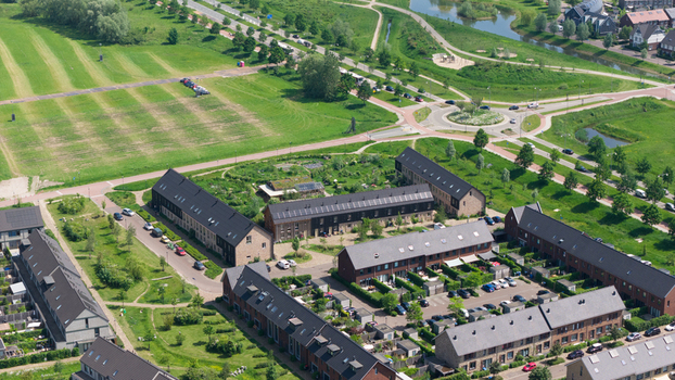 Aerial view of the sustainable housing at Ecodorp Zuiderveld with modern rooftops and lush green gardens in Nijmegen Gelderland Netherlands. Aerial view of the sustainable housing at Ecodorp Zuiderveld with modern rooftops and lush green gardens in Nijmegen Gelderland Netherlands.