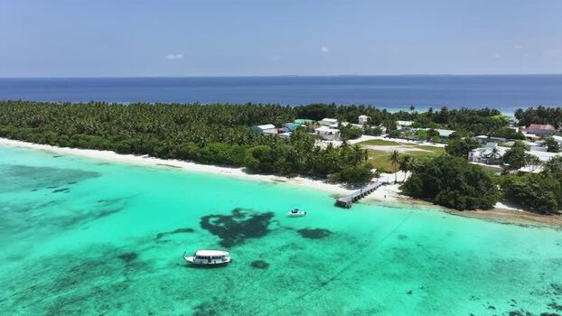 Aerial view of tropical island with turquoise water and palm trees Maldives. Aerial view of tropical island with turquoise water and palm trees Maldives.