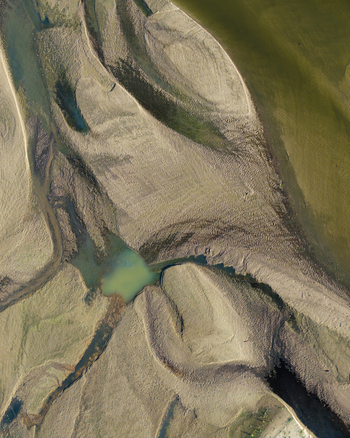 Aerial view of Zawadowskie Islands Nature Reserve featuring intricate sandy riverbanks and shallow water channels along the Vistula River in Masovian Voivodeship Poland.