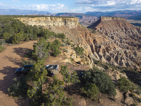 Aerial view of an overland teardrop camper trailer parked on the edge of Gooseberry Mesa overlooking the rugged red rock canyons of Zion National Park Hurricane Utah United States.
