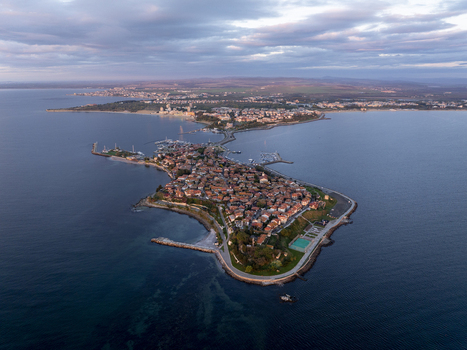 Aerial view of the historic peninsula of Nessebar with its traditional red tiled rooftops and stone architecture surrounded by the Black Sea in Nessebar Burgas Bulgaria. Aerial view of the historic peninsula of Nessebar with its traditional red tiled rooftops and stone architecture surrounded by the Black Sea in Nessebar Burgas Bulgaria.