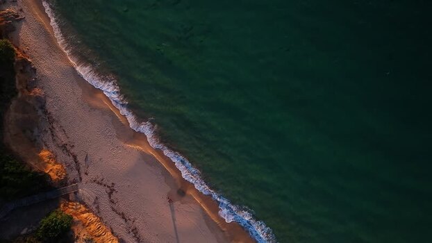 Aerial view of the sandy beach and turquoise waves at sunset Italy. Aerial view of the sandy beach and turquoise waves at sunset Italy.