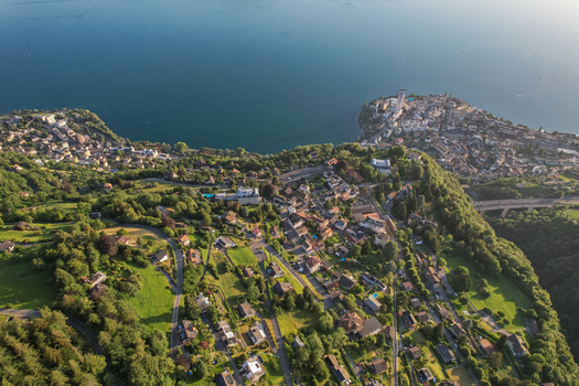 Aerial view of Glion village overlooking Lake Geneva with lush green hills winding roads and residential houses Montreux Vaud Switzerland. Aerial view of Glion village overlooking Lake Geneva with lush green hills winding roads and residential houses Montreux Vaud Switzerland.