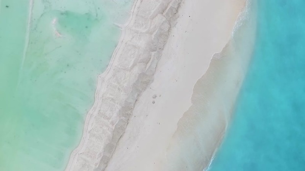 Aerial view of a white sandbar and turquoise waters Maldives.