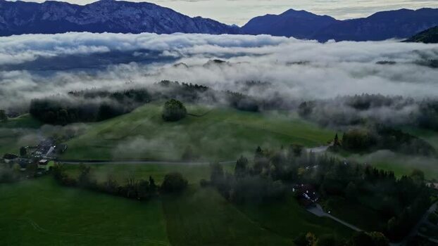 Aerial view of Attersee landscape with clouds over hills Austria.