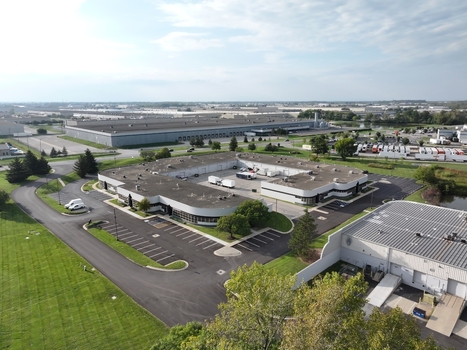 Aerial view of a commercial office complex with a central courtyard parking areas and surrounding industrial warehouses in Indianapolis Indiana United States. Aerial view of a commercial office complex with a central courtyard parking areas and surrounding industrial warehouses in Indianapolis Indiana United States.