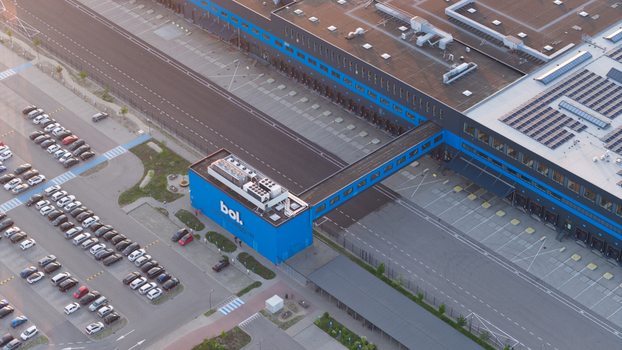 Waalwijk Netherlands 09 May 2026 Aerial view of the Bol. distribution center featuring a large blue building with a connecting bridge extensive parking area and solar panels on the roof. Waalwijk Netherlands 09 May 2026 Aerial view of the Bol. distribution center featuring a large blue building with a connecting bridge extensive parking area and solar panels on the roof.