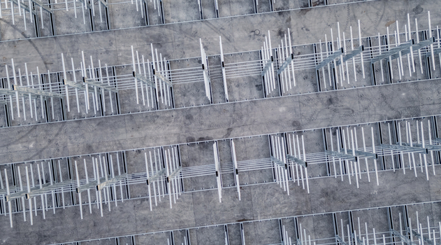 Aerial view of a multi level vehicle storage structure with rows of metal frames on a concrete surface Livron sur Drome Auvergne Rhone Alpes France. Aerial view of a multi level vehicle storage structure with rows of metal frames on a concrete surface Livron sur Drome Auvergne Rhone Alpes France.