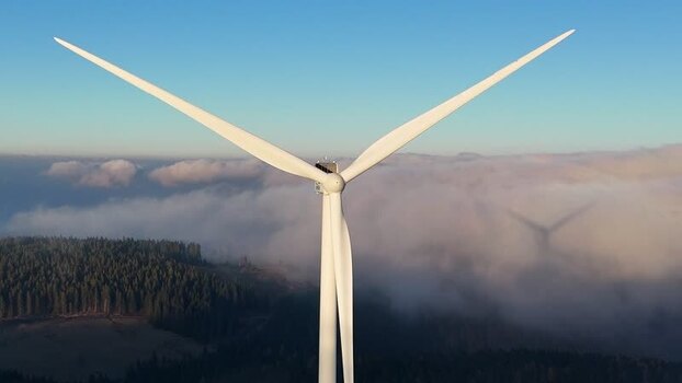 Aerial view of Windpark Freilanderalm above clouds Austria.
