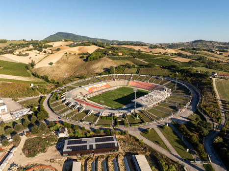 Aerial view of Stadio del Conero with its green pitch and red seating surrounded by rolling hills and vineyards in Ancona Marche Italy. Aerial view of Stadio del Conero with its green pitch and red seating surrounded by rolling hills and vineyards in Ancona Marche Italy.