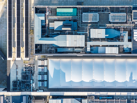Aerial view of the Data Center at Oxford University featuring complex HVAC systems solar panels and a white membrane roof in Oxford England United Kingdom. Aerial view of the Data Center at Oxford University featuring complex HVAC systems solar panels and a white membrane roof in Oxford England United Kingdom.