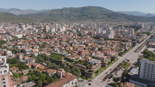 Aerial view of the historic Elbasan Castle walls and the surrounding old town with red tiled rooftops and modern urban sprawl in Elbasan Elbasan County Albania.