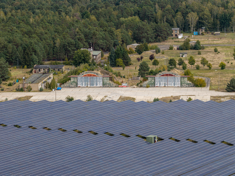 Aerial view of the solar field at the former military airfield in Preschen featuring historic hangars and remnants of the runway and taxiway in Neisse Malxetal Brandenburg Germany. Aerial view of the solar field at the former military airfield in Preschen featuring historic hangars and remnants of the runway and taxiway in Neisse Malxetal Brandenburg Germany.