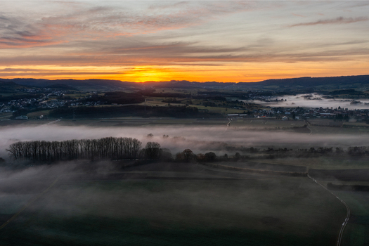 Aerial view of the historic town of Forchheim surrounded by morning mist and rolling hills under a vibrant sunrise sky Forchheim Bavaria Germany. Aerial view of the historic town of Forchheim surrounded by morning mist and rolling hills under a vibrant sunrise sky Forchheim Bavaria Germany.