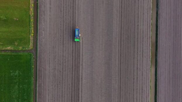 Aerial view of a tractor working on a ploughed field Netherlands.