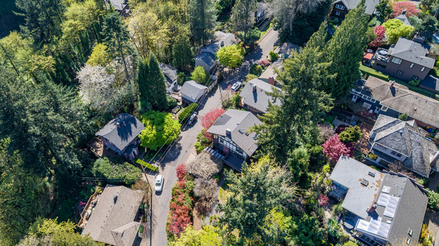 Aerial view of residential houses nestled among lush green and flowering trees along Southwest Imperial Drive in Portland Oregon United States. Aerial view of residential houses nestled among lush green and flowering trees along Southwest Imperial Drive in Portland Oregon United States.