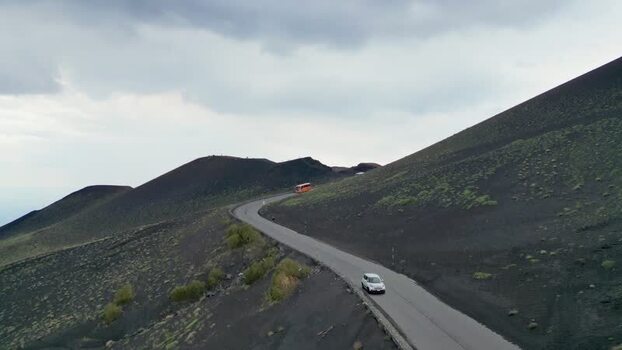 Aerial view of cars on a winding road on Mount Etna Italy. Aerial view of cars on a winding road on Mount Etna Italy.