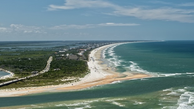 Aerial view of Matanzas Inlet showing the waterway connecting the Atlantic Ocean to the coast with sandy beaches and vegetation in St. Johns County Florida United States. Aerial view of Matanzas Inlet showing the waterway connecting the Atlantic Ocean to the coast with sandy beaches and vegetation in St. Johns County Florida United States.