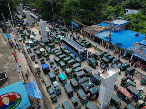 Rajshahi Rajshahi Division Bangladesh 26 September 2026 Aerial view of a congested street filled with numerous green auto rickshaws and a bus with construction pillars. Rajshahi Rajshahi Division Bangladesh 26 September 2026 Aerial view of a congested street filled with numerous green auto rickshaws and a bus with construction pillars.