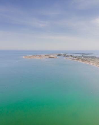 Aerial view of the Ebro Delta featuring its sandy coastline and turquoise Mediterranean waters under a clear sky Catalonia Spain. Aerial view of the Ebro Delta featuring its sandy coastline and turquoise Mediterranean waters under a clear sky Catalonia Spain.