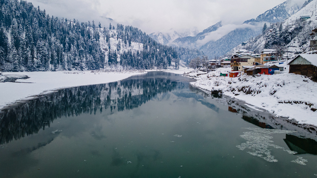 Aerial view of the serene snow dusted Sharda reflecting the cloudy sky nestled amid the majestic snow covered mountains Sharda Azad Kashmir Pakistan. Aerial view of the serene snow dusted Sharda reflecting the cloudy sky nestled amid the majestic snow covered mountains Sharda Azad Kashmir Pakistan.