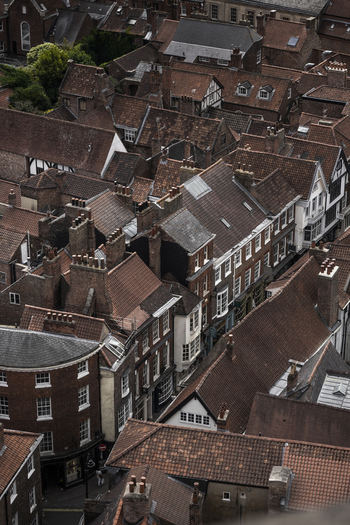 Aerial view of the historic city center of York with its dense collection of traditional red tiled rooftops chimneys and narrow streets in York England United Kingdom.