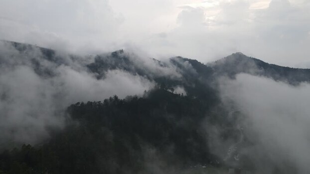 Aerial view of misty mountains and forests in Tawangmangu Indonesia. Aerial view of misty mountains and forests in Tawangmangu Indonesia.