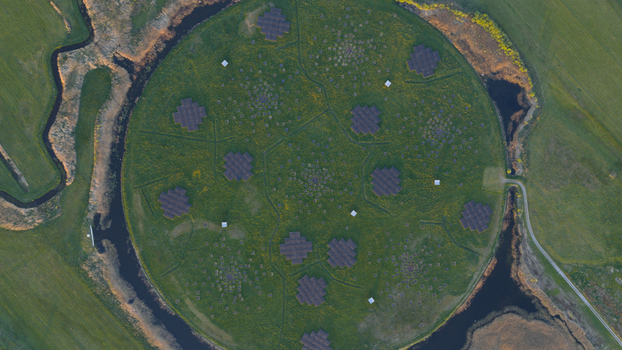 Aerial view of the LOFAR superterp radio telescope array with its circular green field and antenna clusters surrounded by a water channel in Buinen Drenthe Netherlands. Aerial view of the LOFAR superterp radio telescope array with its circular green field and antenna clusters surrounded by a water channel in Buinen Drenthe Netherlands.