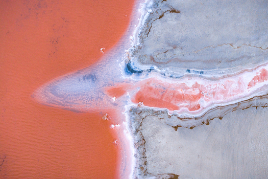 Aerial view of pink waters contrasting with the grey land Salt Lake City Utah United States. Aerial view of pink waters contrasting with the grey land Salt Lake City Utah United States.