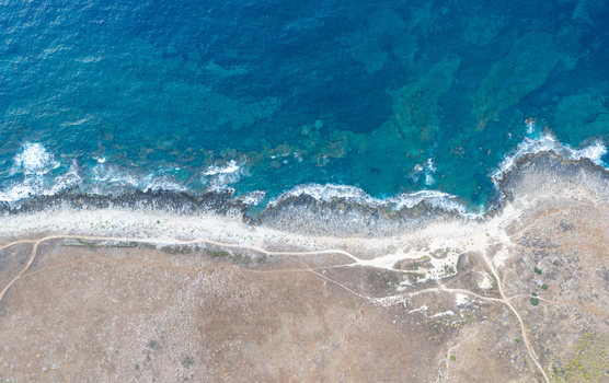 Aerial view of Riserva Naturale Orientata dello Zingaro with its rugged coastline turquoise sea rocky shore and winding dirt paths in San Vito Lo Capo Sicilia Italy. Aerial view of Riserva Naturale Orientata dello Zingaro with its rugged coastline turquoise sea rocky shore and winding dirt paths in San Vito Lo Capo Sicilia Italy.