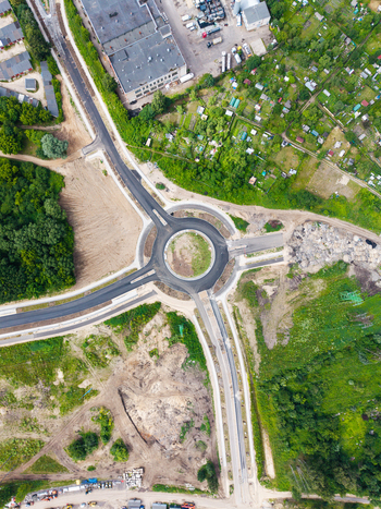 Aerial view of the Southern Bridge project construction site featuring a newly paved roundabout surrounding green areas and road infrastructure in Riga Latvia. Aerial view of the Southern Bridge project construction site featuring a newly paved roundabout surrounding green areas and road infrastructure in Riga Latvia.