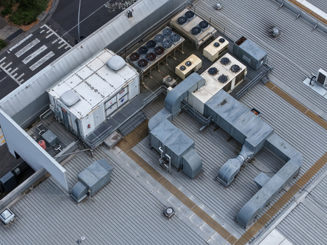Melbourne VIC Australia 25 September 2026 Aerial view of industrial rooftop HVAC units ventilation ducts and machinery on a metal roof.