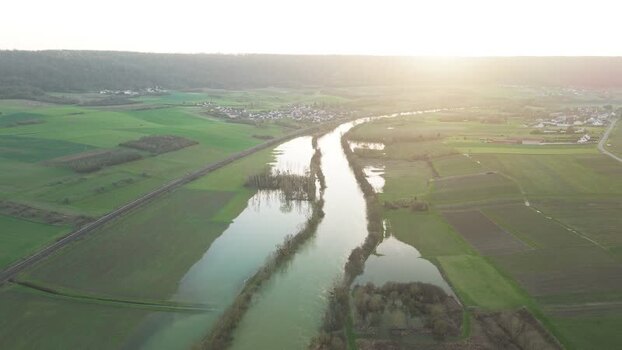 Aerial view of river flowing through fields France.