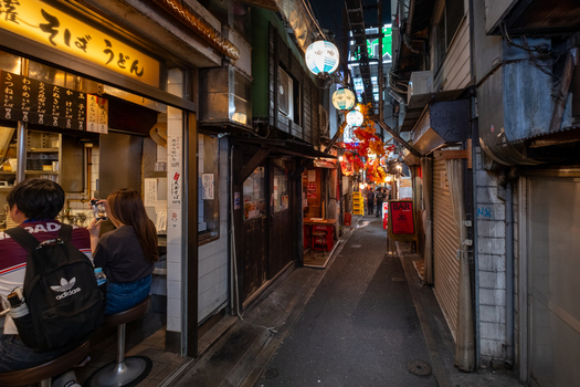 Shinjuku City Japan 30 September 2025 View of Omoide Yokocho s narrow alley glowing lanterns casting warm hues on the textured walls while diners savor noodles under the soft light. Shinjuku City Japan 30 September 2025 View of Omoide Yokocho s narrow alley glowing lanterns casting warm hues on the textured walls while diners savor noodles under the soft light.
