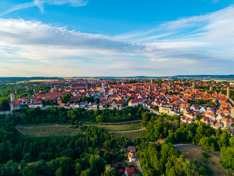 Aerial view of the historic medieval town with red tiled rooftops ancient walls and lush greenery in Rothenburg ob der Tauber Bavaria Germany. Aerial view of the historic medieval town with red tiled rooftops ancient walls and lush greenery in Rothenburg ob der Tauber Bavaria Germany.