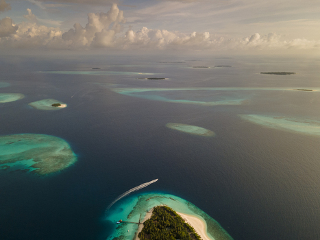 Aerial view of islands with white beach and blue ocean Baa Atoll Maldives.