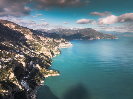 Aerial view of the Amalfi Coast s rugged cliffs meet the turquoise Tyrrhenian Sea where quaint villages cling to the steep slopes Positano Campania Italy. Aerial view of the Amalfi Coast s rugged cliffs meet the turquoise Tyrrhenian Sea where quaint villages cling to the steep slopes Positano Campania Italy.