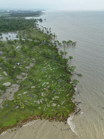 Aerial view of the coastal landscape with lush green vegetation tidal pools and trees along the shoreline in Sitakund Chittagong Division Bangladesh. Aerial view of the coastal landscape with lush green vegetation tidal pools and trees along the shoreline in Sitakund Chittagong Division Bangladesh.