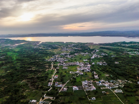 Aerial view of a serene landscape where lush greenery meets the tranquil waters under a pastel sky Chakswari Azad Kashmir Pakistan. Aerial view of a serene landscape where lush greenery meets the tranquil waters under a pastel sky Chakswari Azad Kashmir Pakistan.