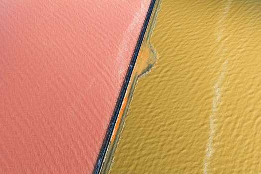 Aerial view of vibrant pink and golden hues blend seamlessly where the salt flats meet the sea creating a stunning contrast in the landscape San Pedro del Pinatar Region of Murcia Spain. Aerial view of vibrant pink and golden hues blend seamlessly where the salt flats meet the sea creating a stunning contrast in the landscape San Pedro del Pinatar Region of Murcia Spain.