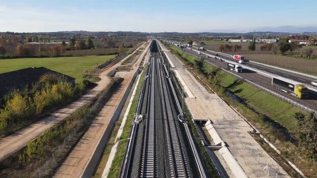Aerial view of railway tracks and highway in Italy.