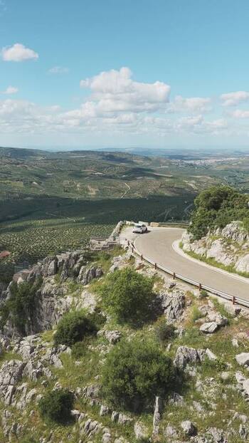 Aerial view of a winding mountain road and olive groves Spain.