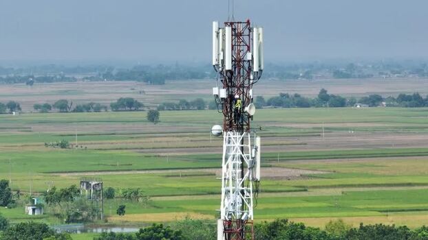Aerial view of a technician working on a telecommunications tower. Aerial view of a technician working on a telecommunications tower.