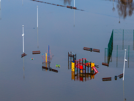 Aerial view of a flooded children s playground with colorful slides and climbing frames submerged in water Kedainiai Kaunas County Lithuania. Aerial view of a flooded children s playground with colorful slides and climbing frames submerged in water Kedainiai Kaunas County Lithuania.